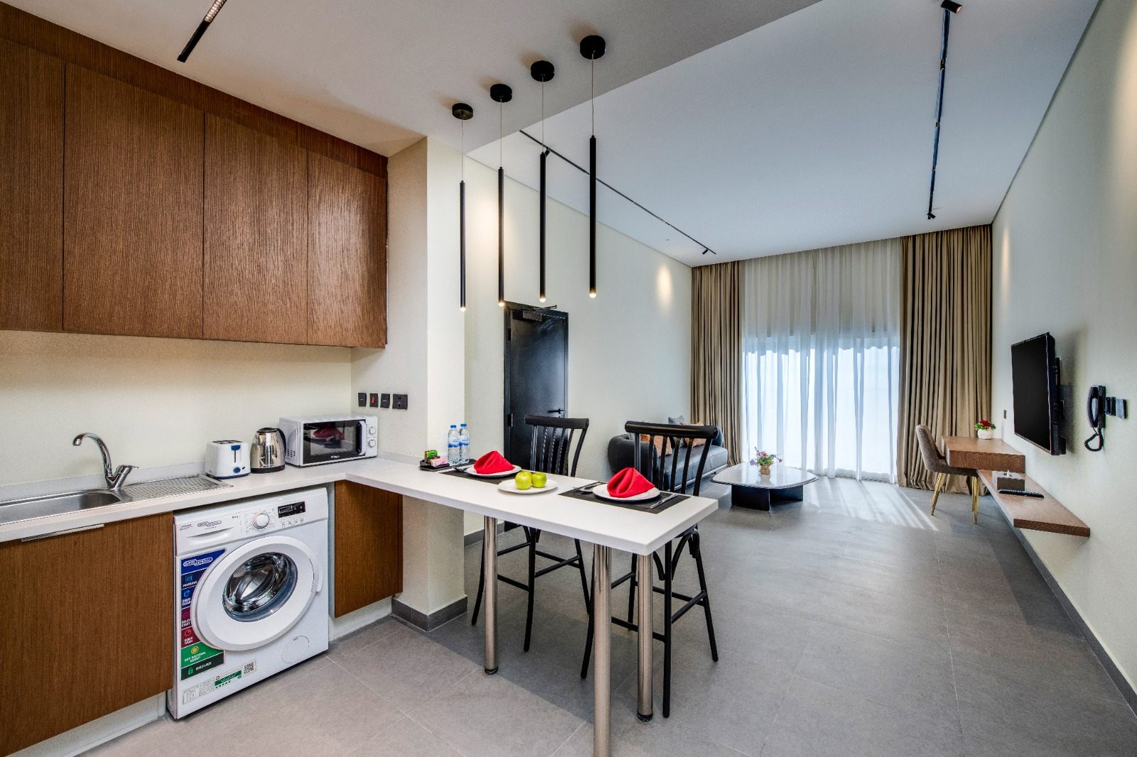 Living, dining and kitchen with breakfast bar and washer
